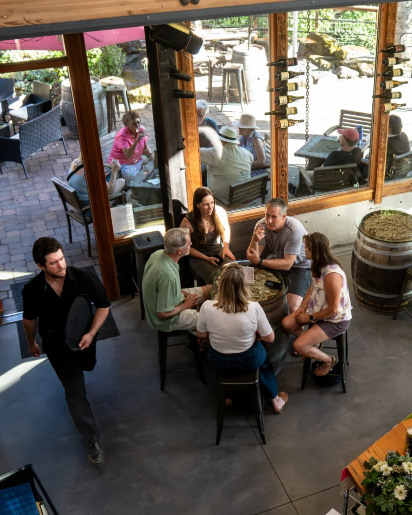 Group enjoying wine tasting at rustic winery